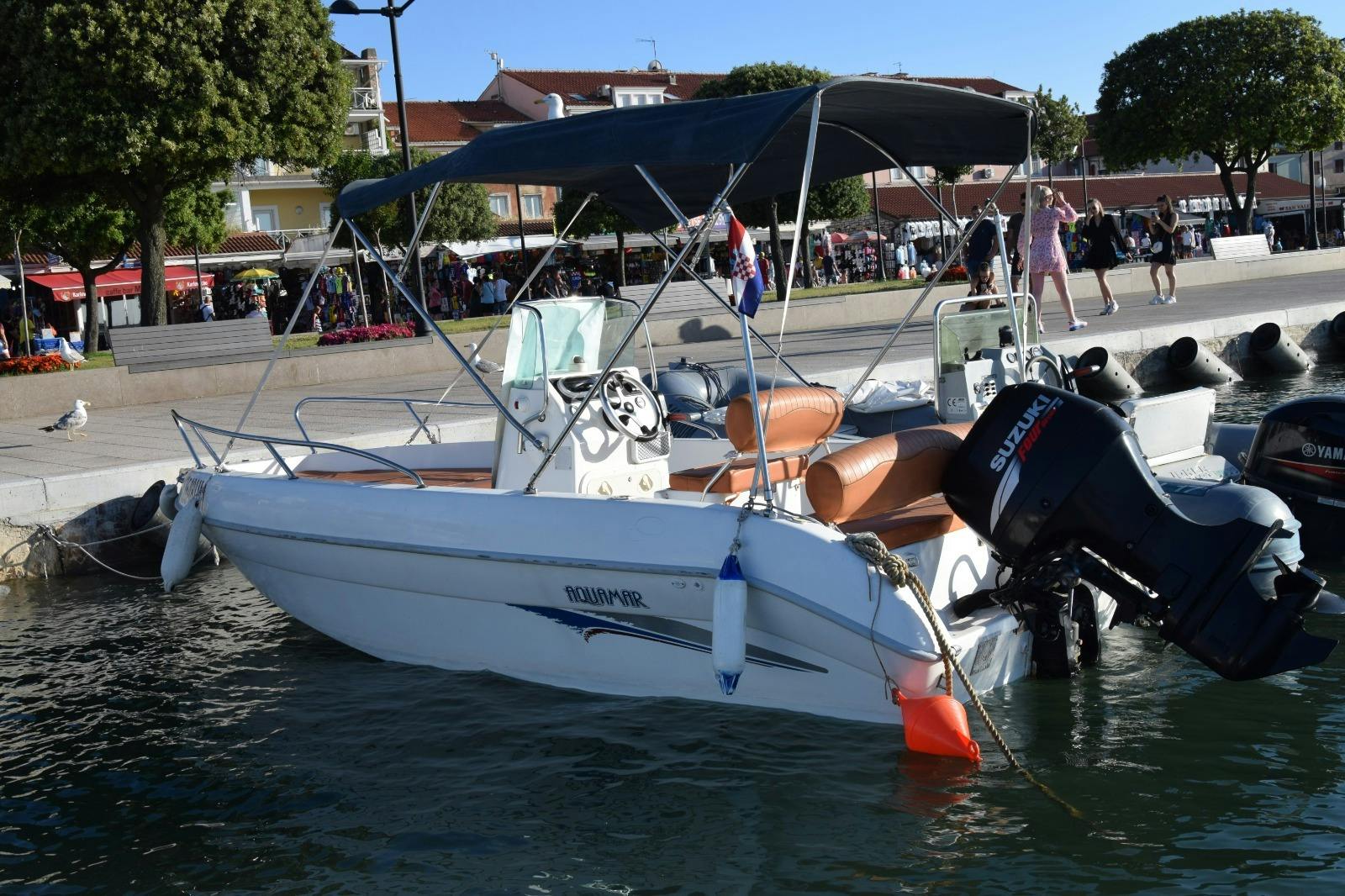 Person drives a boat of Boat Rental in Umag (up to 7 people) with Blue Gem Umag.