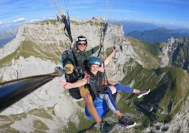 A person and their instructor during the tandem Paragliding over Lake Annecy - Origin'ail with K2 Outdoor Annecy.