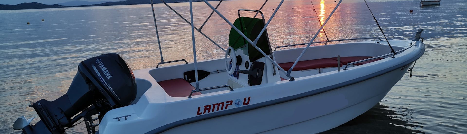 The boat with the beautiful Greek sunset during the Boat Rental in Ouranoupoli (up to 6 people) without Licence with Rent a Boat Lampou.