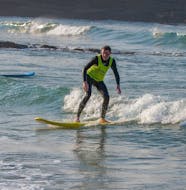 A young man is learning how to surf during the Private Surf Lessons (from 12 y.) for All Levels in Ericeira with Activity Surf Center Ericeira.