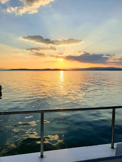 Sunset view of Halikidiki from the boat during Party Boat Trip around the Island of Ammouliani with Eirinikos Glassbottom Daily & Private Cruises.