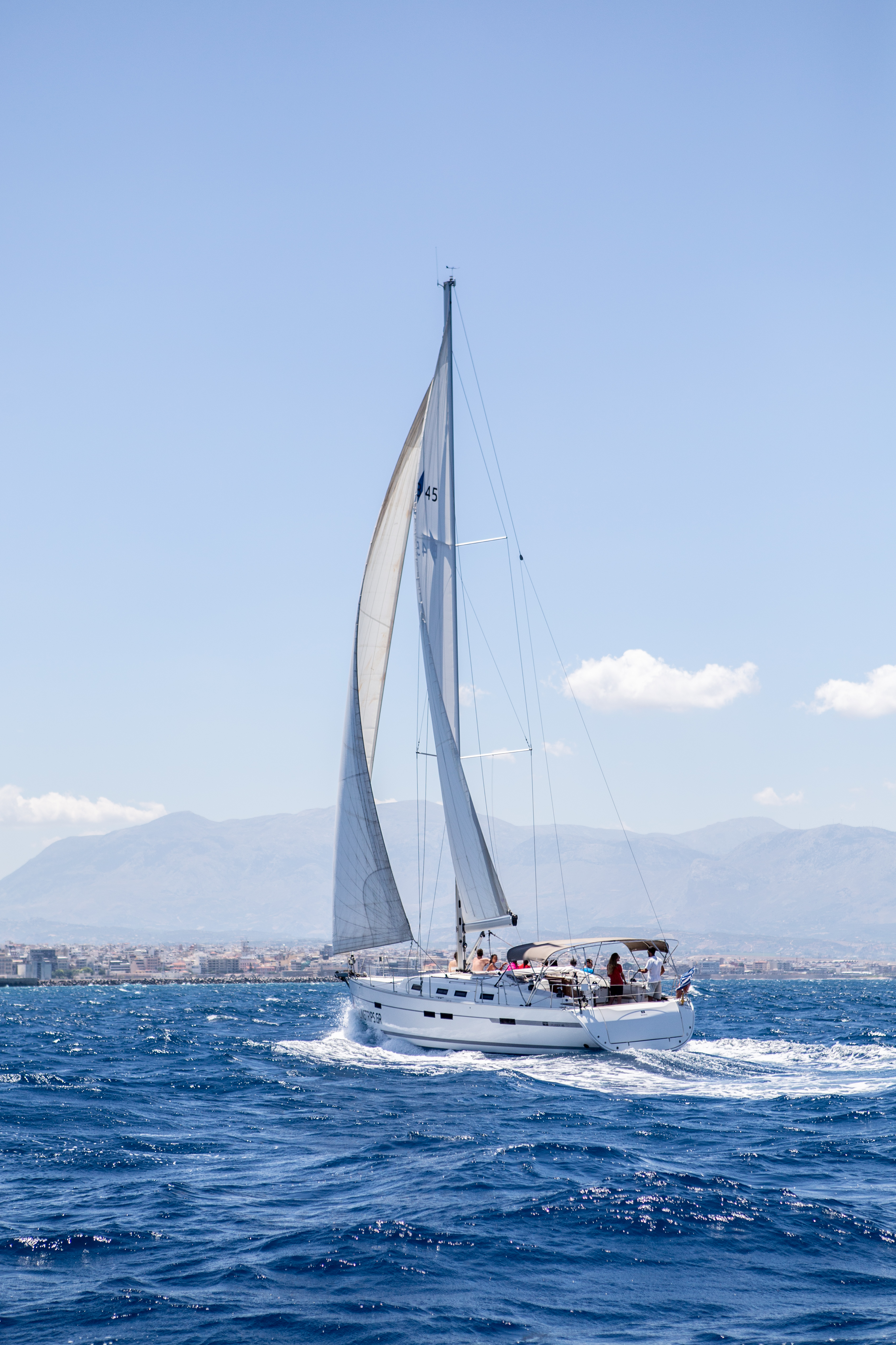 Sailboats in a bay of Dia Island during the Private Sailing Trip to Dia Island with Snorkeling - Full Day with Sailingtrips.gr Heraklion.