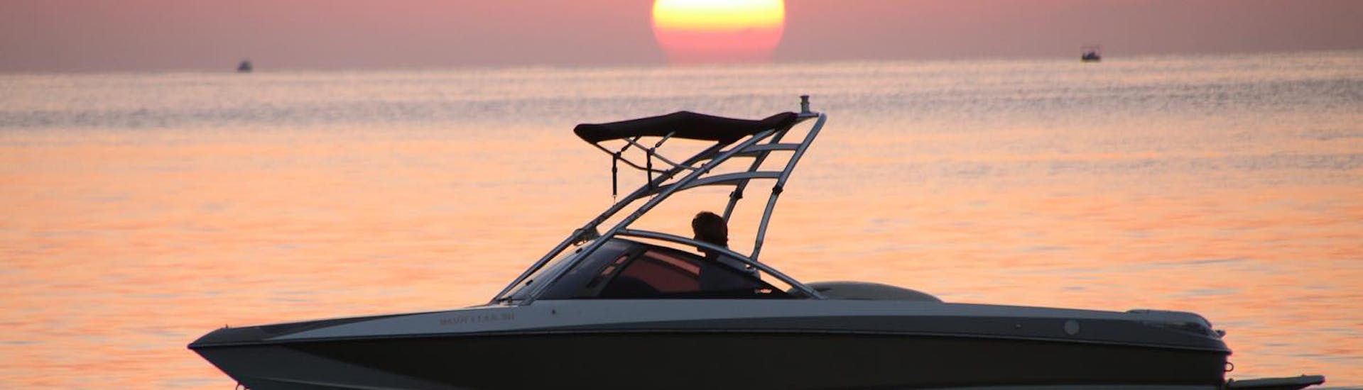 The boat under the sunset during the Private Boat Trip along Mirabello Bay from Ammoudi with Amoudi Watersports.
