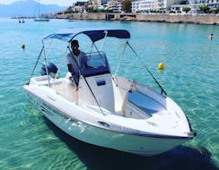 A young man on the boat during the Boat Rental in Agios Nikolaos (up to 5 people) without Licence with Amoudi Watersports.