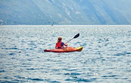 A young woman in the middle of the sea during the Sea Kayaking at Ammoudi Beach in Agios Nikolaos with Amoudi Watersports.