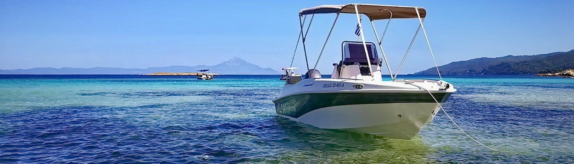 The boat is on the crystal clear waters of the region during the Boat Rental in Vourvourou (up to 5 people) without Licence with Alfa Boat Rental﻿ Vourvourou.