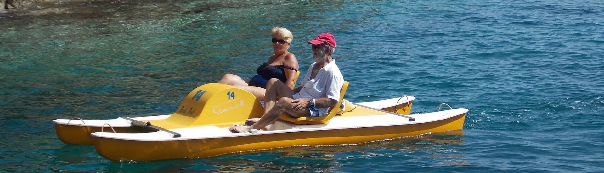 Two old people are spending a peaceful moment together on the pedal boat during the Pedal Boat at Bali on Crete with The Skippers Bali.