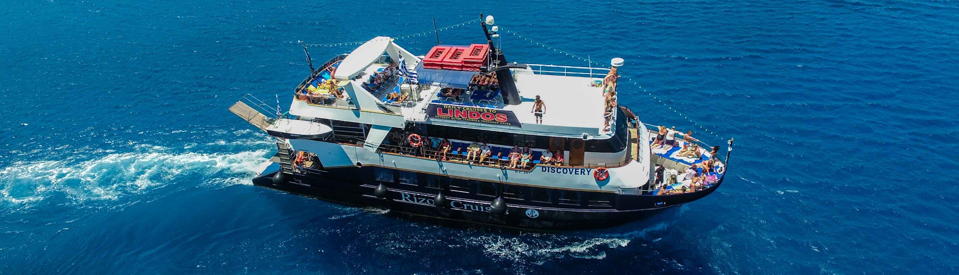 The boat "Discovery" navigates on the Mediterranean Sea during the Full-Day Boat Trip to Symi Island with Swimming with Rizos Cruises Rhodes.
