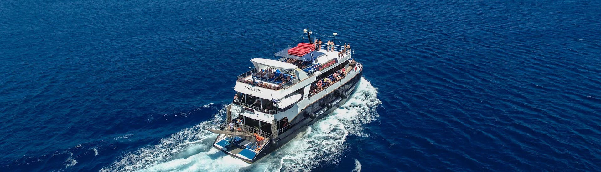 The boat "Discovery" navigates on the Mediterranean Sea during the Full-Day Boat Trip to Lindos with Swimming with Rizos Cruises Rhodes.