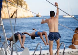Unos amigos se bañan en el mar Mediterráneo durante un paseo en catamarán en Valencia con baño con Mundo Marino.