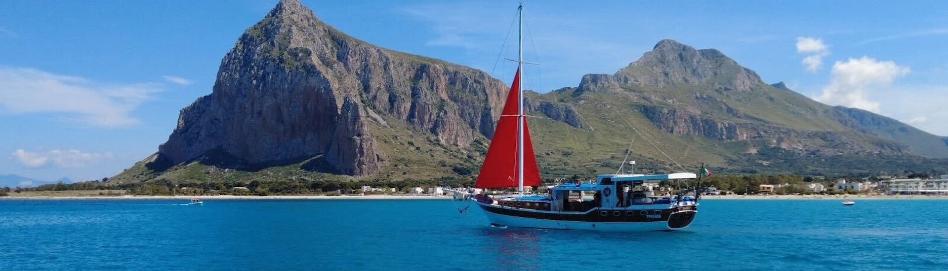 Our beautiful boat in front of the coast of San Vito Lo Capo during the Boat trip along the Riserva dello Zingaro with Lunch with San Vito Coast Charter.