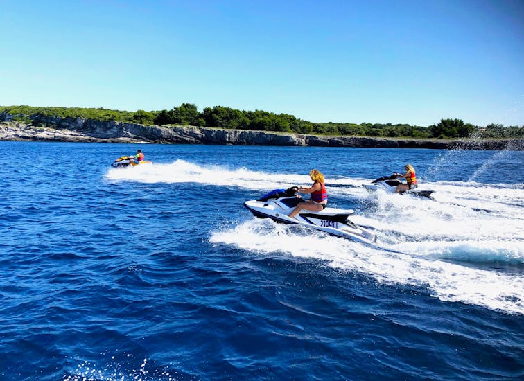 Group of people riding through the sea while doing the Jet Ski Safari from Banjole to Levan Island with Seafun Medulin.
