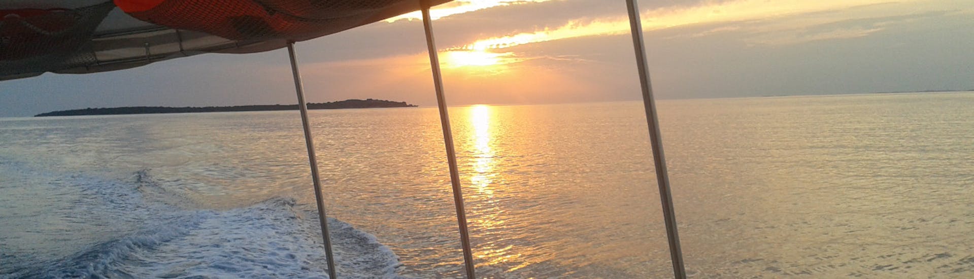 Puesta de sol durante el paseo en barco al atardecer en las Islas Brijuni con avistamiento de delfines con Elen Taxi Boat Fažana.
