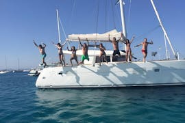 People having fun in a private boat trip from San Antonio to Cala Comte with Goa Catamaran Ibiza.