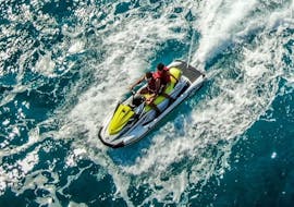 A couple on a jet ski in the middle of the waves during the Jet Ski Safari to the Calanques de Piana from Cargèse with Fun Jet Location Cargèse.