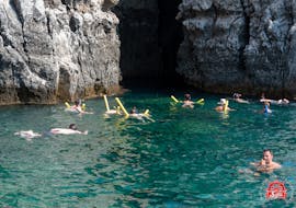 People swimming in turquoise blue water during the Private Boat Trip from Faliraki to Anthony Quinn Bay with Swimming with Sofia Sea Cruises Faliraki.