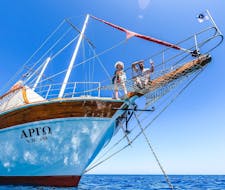 Two people sitting on a sailing boat during the All Inclusive Boat Trip to Anthony Quinn Bay & Kallithea Springs with Snorkeling with Royal Sailing Rhodes.