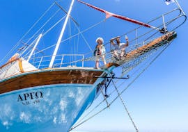 Two people sitting on a sailing boat during the All Inclusive Boat Trip to Anthony Quinn Bay & Kallithea Springs with Snorkeling with Royal Sailing Rhodes.