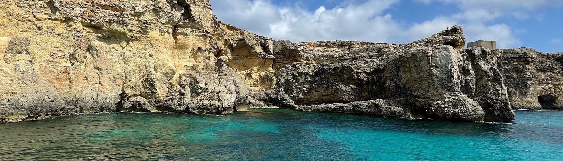 The rocky formations viewed from the boat during the Boat Trip to Comino with Snorkeling & Swimming at the Blue Lagoon with Oh Yeah Malta.