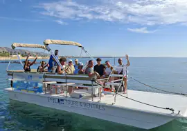 Group on a boat trip with Ioniam Rent Boat Avola Happy guests wave from the deck of a boat during a trip from Avola to Marzamemi with swimming stops and snorkeling, provided by Ioniam Rent Boat Avola.