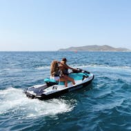 Two people enjoying an exciting jet ski safari in Ibiza, touring Playa d'en Bossa and Santa Eulalia with Enjoy Watersports Ibiza.