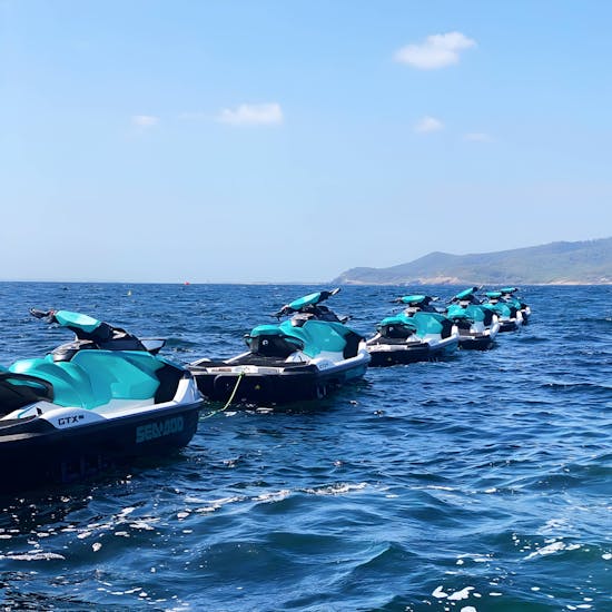 A fleet of jet skis parked in the sea during an exciting safari in Ibiza, exploring Playa d'en Bossa and Santa Eulalia with Enjoy Watersports Ibiza.