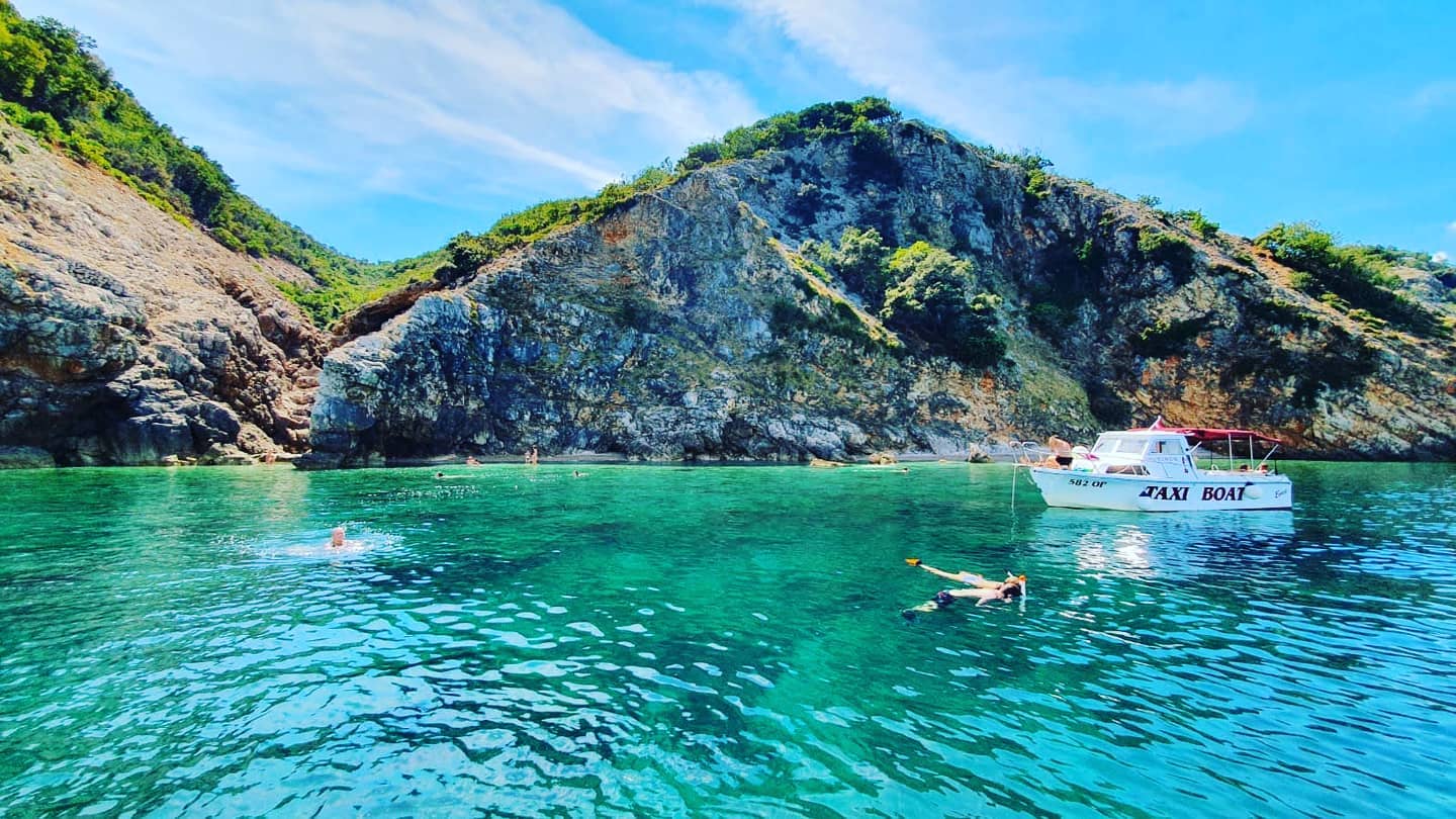 Friends swimming in the sea during the Boat Trip to Moščenićka Draga and the Cliffs of Brseč with Snorkeling with ML Aquatics Opatija.