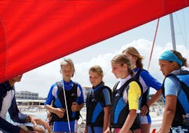 Some children listening to the explanations of their instructor in a family sailing course in Formentera from Es Pujols for beginners with Wet4Fun Formentera.