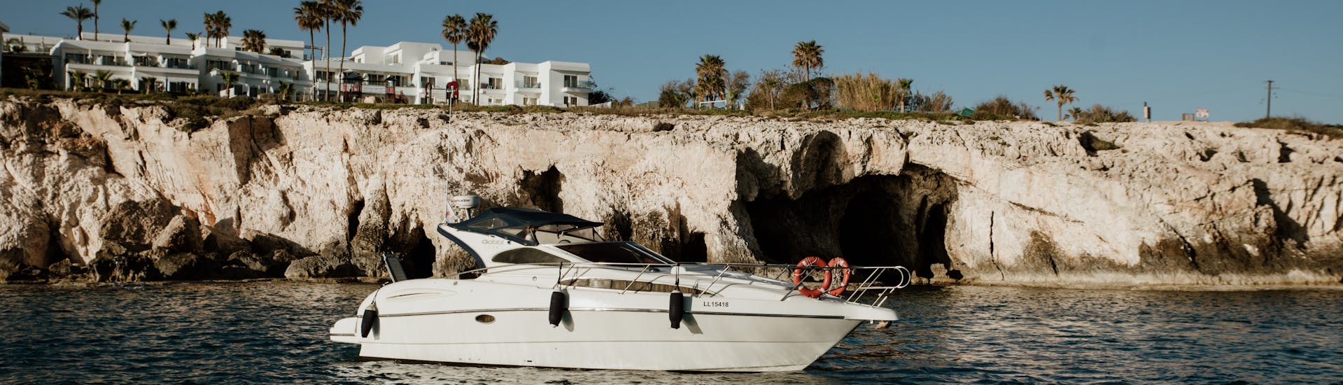 Boat in front of the coastline during the private luxury boat trip from Ayia Napa with swimming stops with Azure Yacht Club Cyprus with Azure Yacht Club Cyprus.