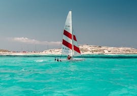 A sailing boat navigating towards the island of S'Espalmador in Formentera during an private boat trip with Wet4Fun Formentera.