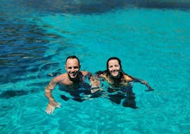 Two people swimming during the Private RIB Boat Trip from Marsala to Favignana & Levanzo with Lunch & Snorkeling with Calmapiatta Marsala.