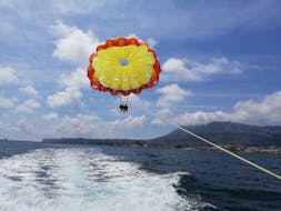 A person during a parasailing flight in Denia with Mundo Marino Denia during a boat trip.