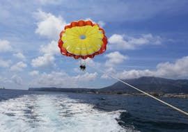 A person during a parasailing flight in Denia with Mundo Marino Denia during a boat trip.