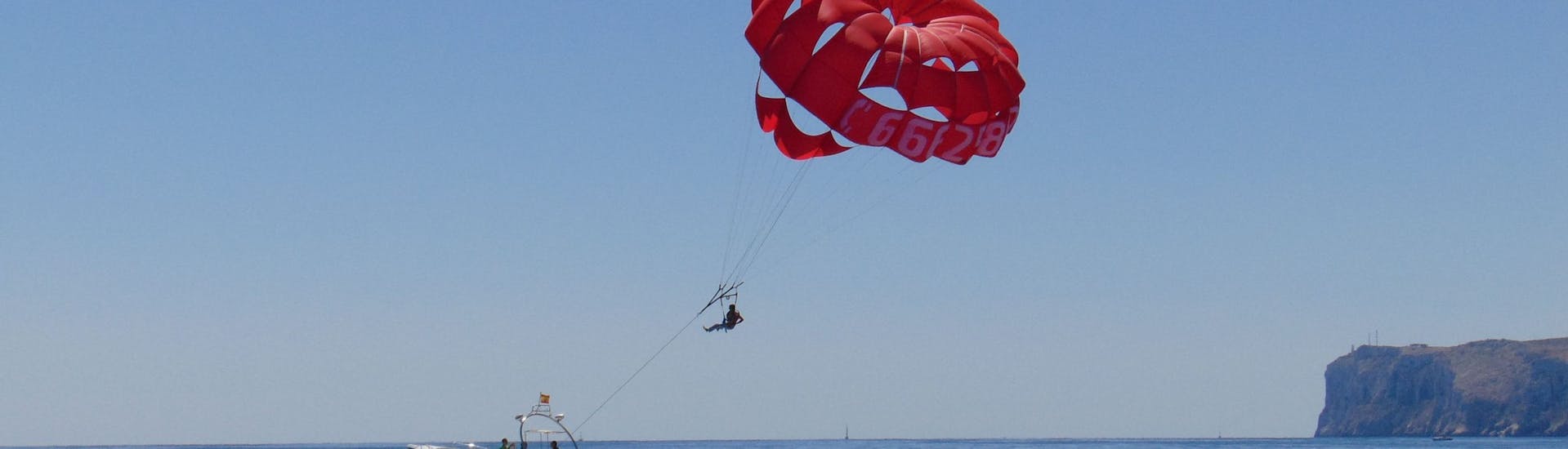 Aerial views of a parasailing flight in Denia with Mundo Marino Denia during a boat trip.