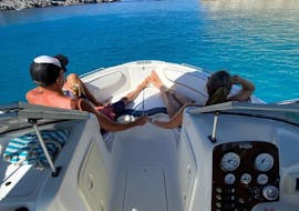 Two people enjoying a Private Boat Trip from Traganou Beach to Anthony Quinn Bay with Snorkeling with Traounou Water Sports & Boats.