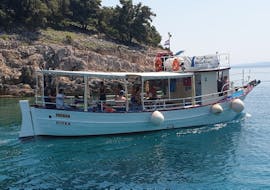 The boat is navigating during the Boat Trip to Krušija Bay with Swimming at the Blue Cave & Golden Beach with Neptun Boat Tours Krk.