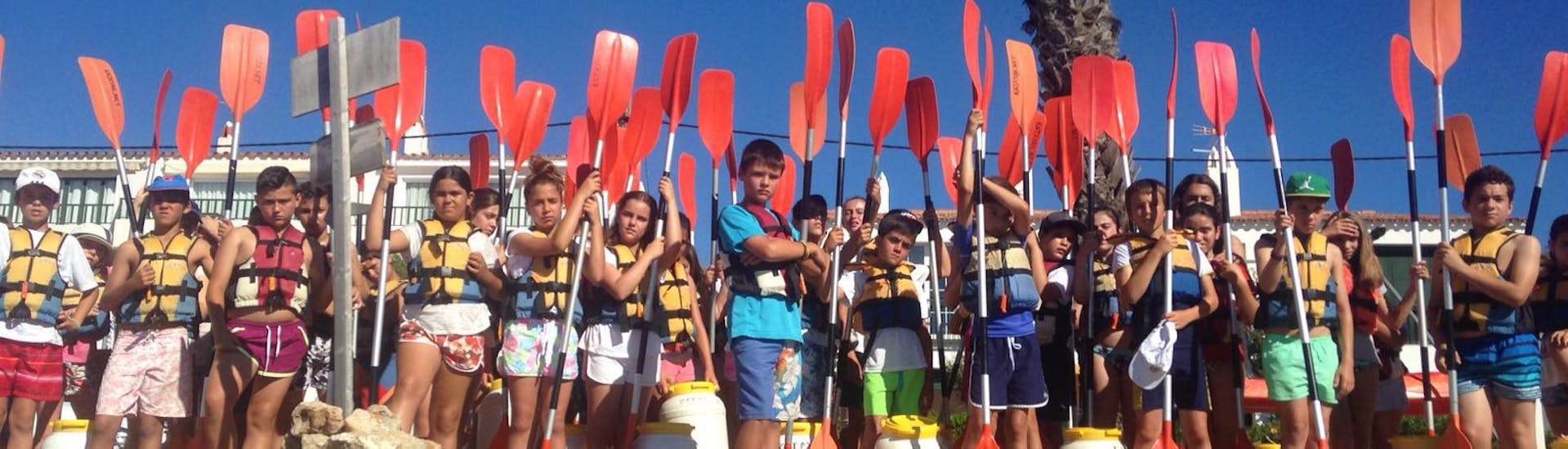 Many children about to start their first guided kayak trip in Fornells bay & Cabra Salada in Menorca.