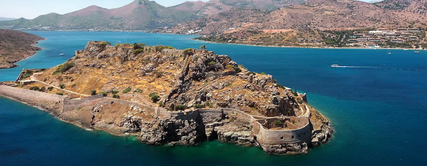 View of an island you can admire during the Boat Trip to Spinalonga & Agios Nikolaos with BBQ & Swimming at Kolokytha.