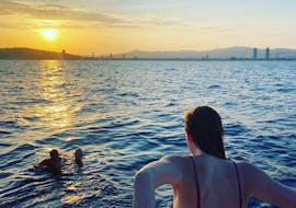 People swimming during the Private Sailing Boat Trip in Barcelona with Sunset Option from Sailing Experience Barcelona.