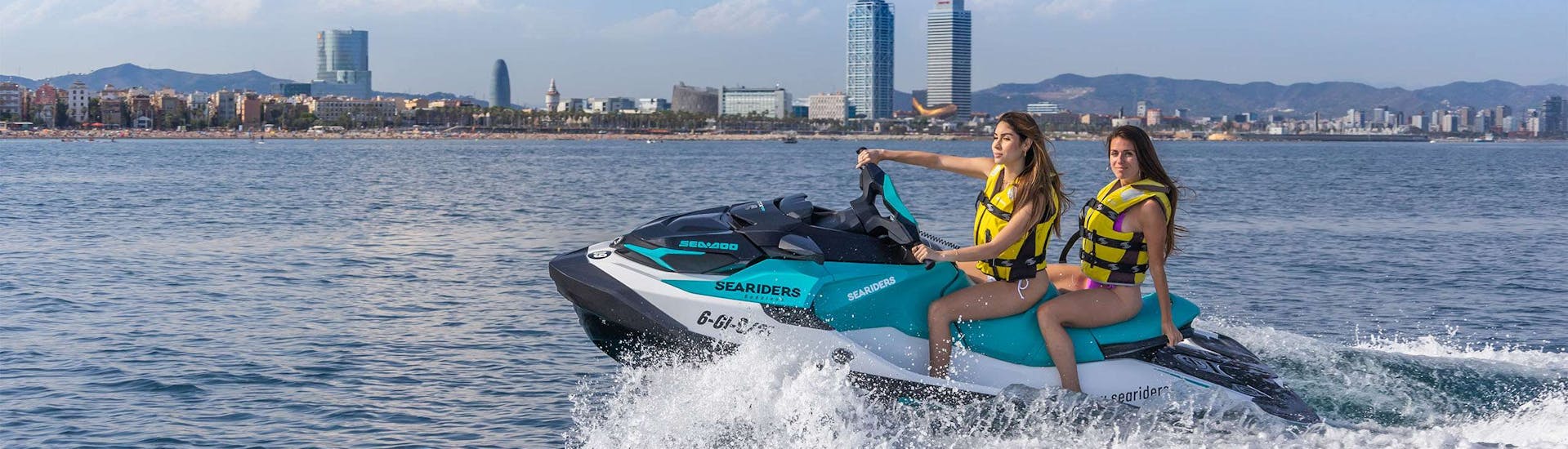 Two girls during a jet ski safari from Badalona to Llobregat's River in Barcelona with Sea Riders Badalona.