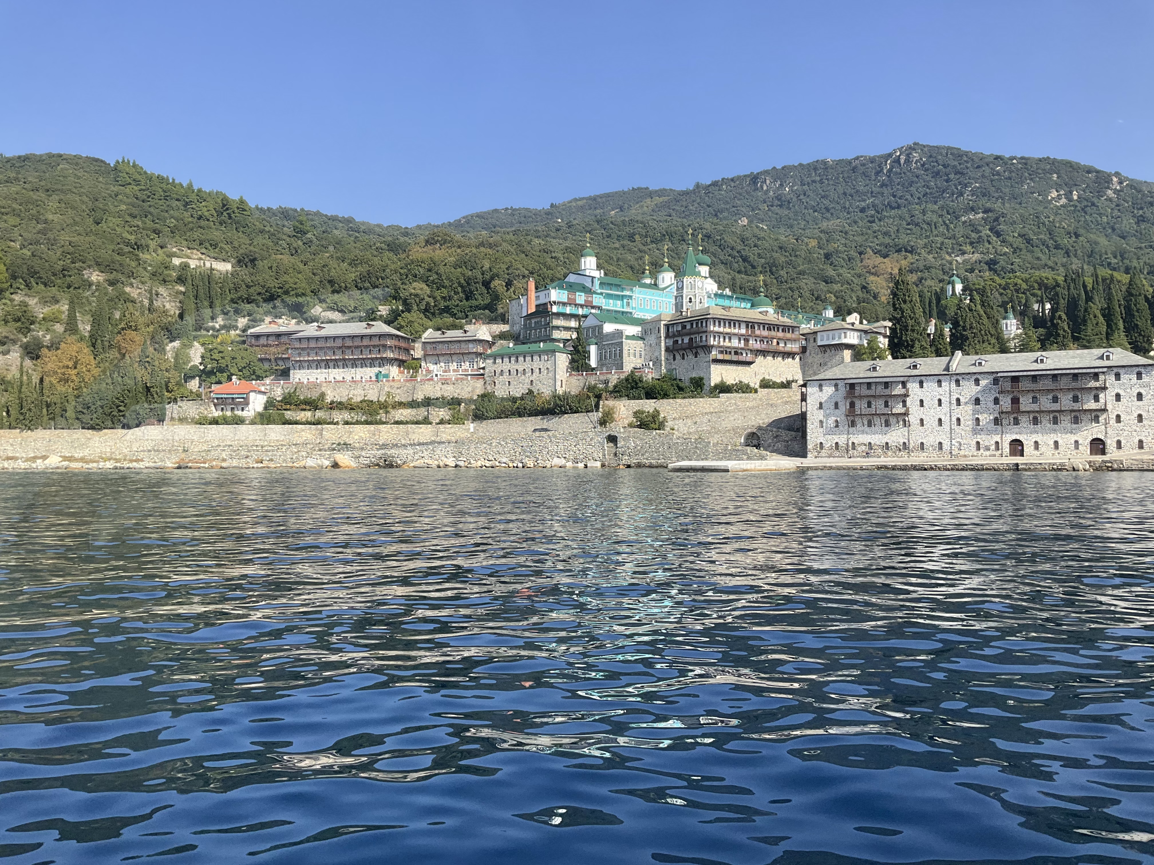 De kloosters van de berg Athos zijn te bewonderen tijdens een boottocht vanuit Ouranoupoli met Calypso Cruises Ouranoupoli, gebouwd tegen een weelderige groene heuvel langs het water.