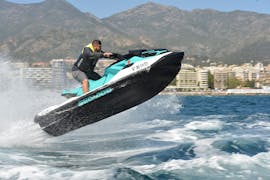 A boy doing jumps with a jet ski during a Jet Ski from Marbella along Costa del Sol from Marbella Renting Boat.