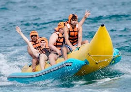 Algunos amigos en una banana Boat y otros hinchables en la costa de Barcelona con Brutal Watersports Barcelona.