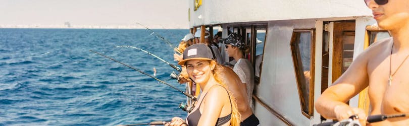 A girl is doing a Fishing Glass-bottom Boat Trip with Lunch & Snorkeling at Zenobia Shipwreck from Larnaca Napa Sea Cruises.