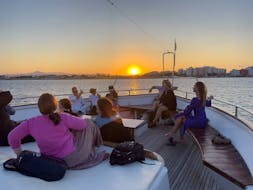 People enjoying a Glass-Bottom Boat Trip to Mackenzie Beach at Sunset with Music and Wine from Larnaca Napa Sea Cruises.