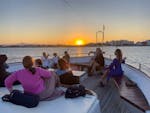 People enjoying a Glass-Bottom Boat Trip to Mackenzie Beach at Sunset with Music and Wine from Larnaca Napa Sea Cruises.