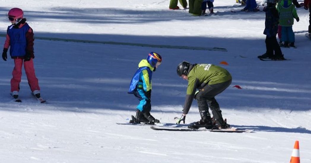 A little skier and an instructor during the Kids Ski Lessons (from 4 y.) for All Levels.