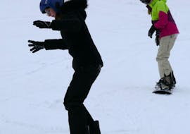 Two kids practicing during their Snowboarding Lessons (from 4 y.) for All Levels from Skischule Schneider Events Geißkopf.