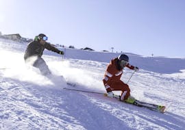 A ski instructor and an adult during the Private Ski Lessons for Adults of All Levels from Official Swiss Ski School Rougemont Gstaad.