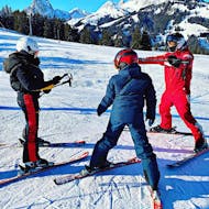 A ski instructor and two students during their Private Ski Lessons for Kids (from 3 y.) of All Levels from Official Swiss Ski School Rougemont Gstaad.